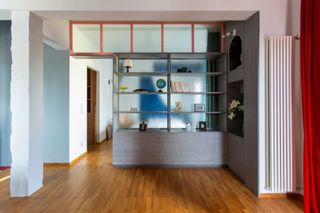 a colorful apartment with a storage room divider
