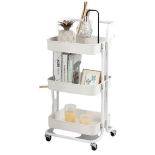 A white storage trolley with decor in it