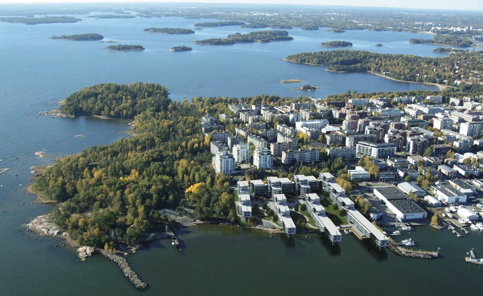 A view of a buildings, trees and water off the coast