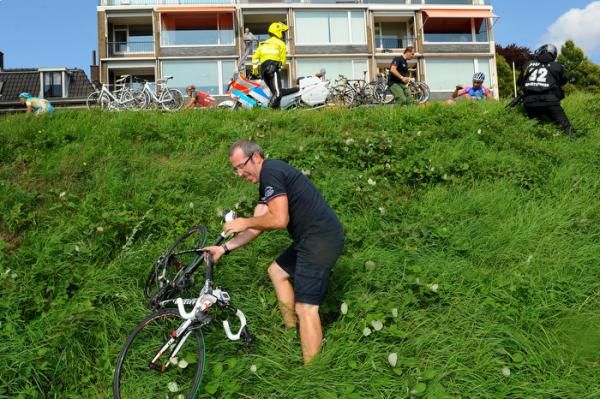 A mechanic recovers a bike from a crash which occurred with 20km to go.