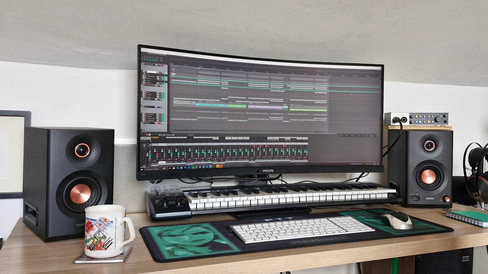 The Edifier MR5 monitor speaker on either side of a large PC monitor.