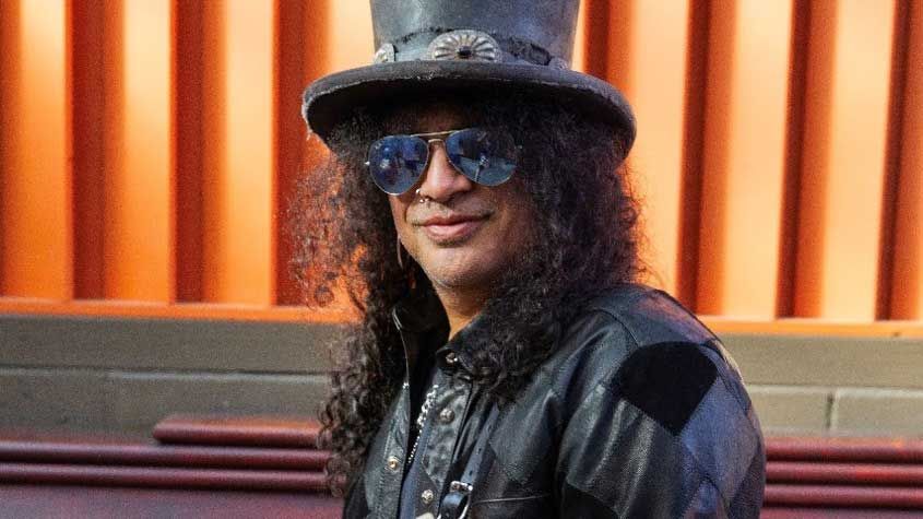 Slash wearing shades and top hat