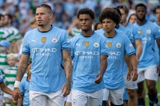 CHAPEL HILL, NORTH CAROLINA - JULY 23: Kalvin Phillips #4, Oscar Bobb #52, and Rico Lewis #82 of Manchester City walk onto the pitch before a match between Manchester City and Celtic at Kenan Stadium on July 23, 2024 in Chapel Hill, North Carolina. (Photo by Eston Parker/ISI Photos/Getty Images)