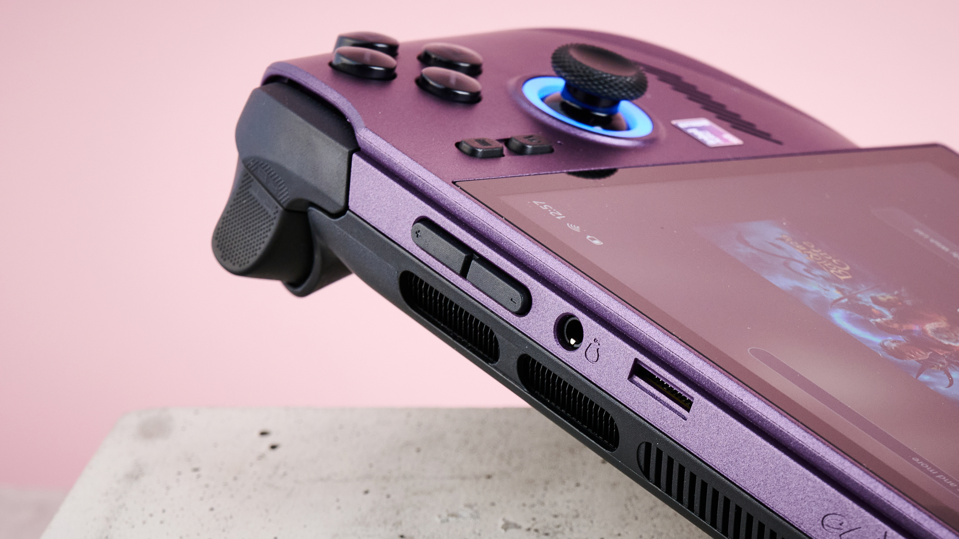 A closeup of the top right corner of MSI Claw 8 EX AI+, showing its right trigger, right shoulder button, volume buttons, headphone jack and microSD card slot.