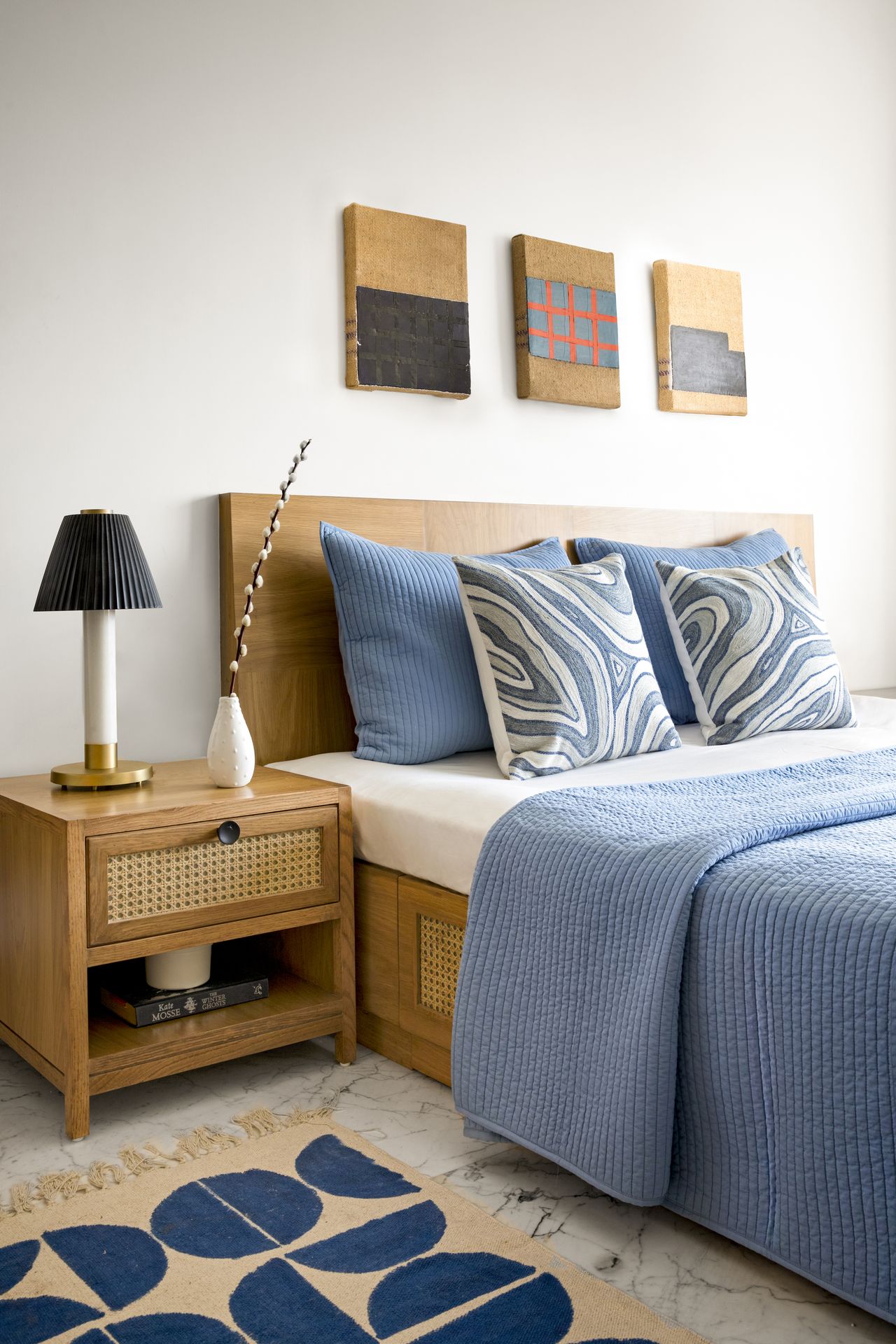A bedroom with a thin bedside rug