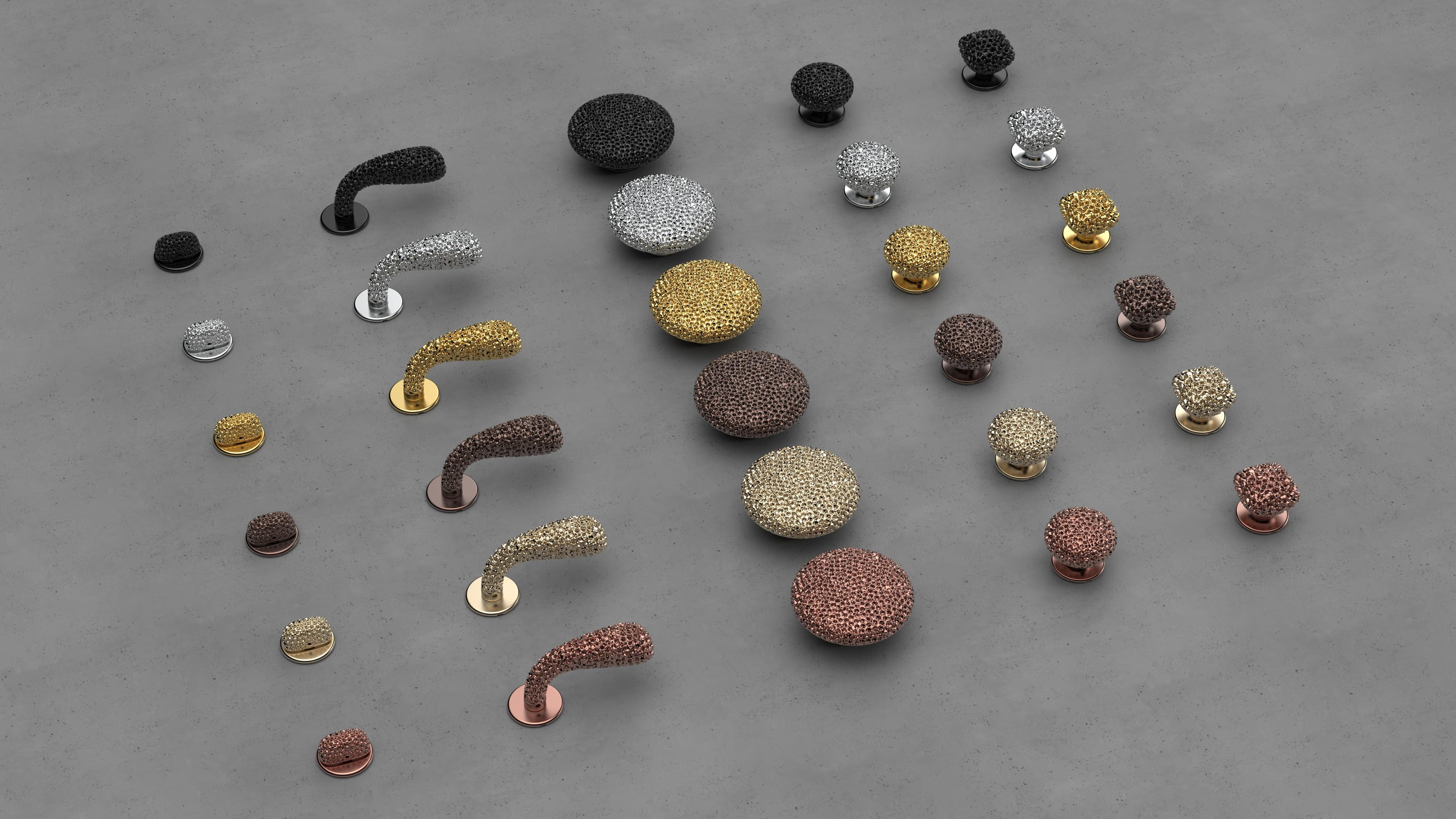 metal handles and knobs laid out on flat, white surface
