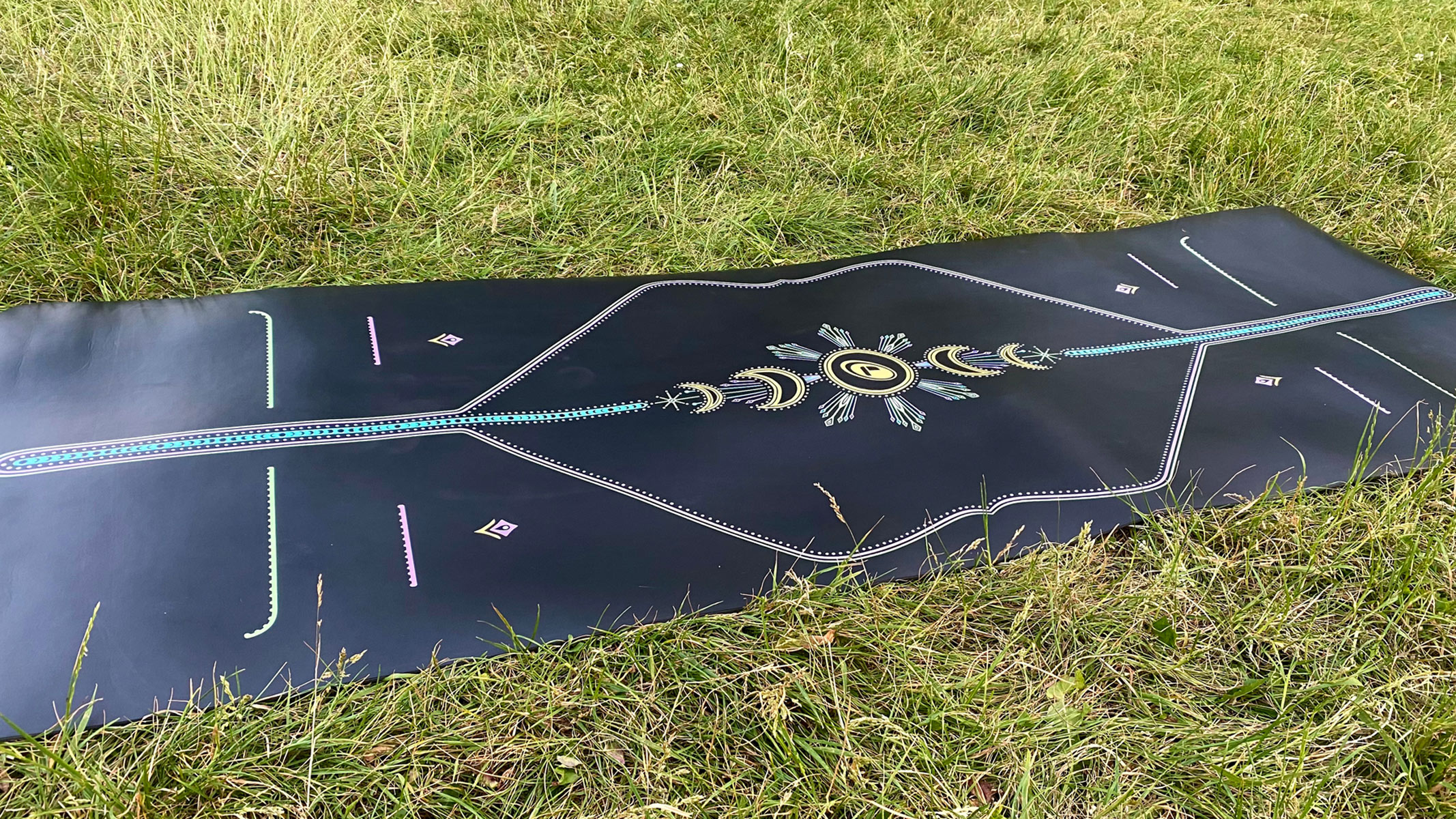 Liforme yoga mat spread on the grass field
