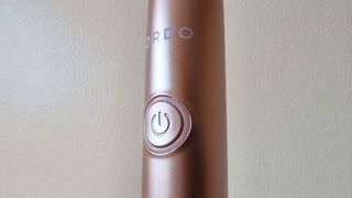 Ordo+ Sonic Electric Toothbrush, a close-up photo of the power button