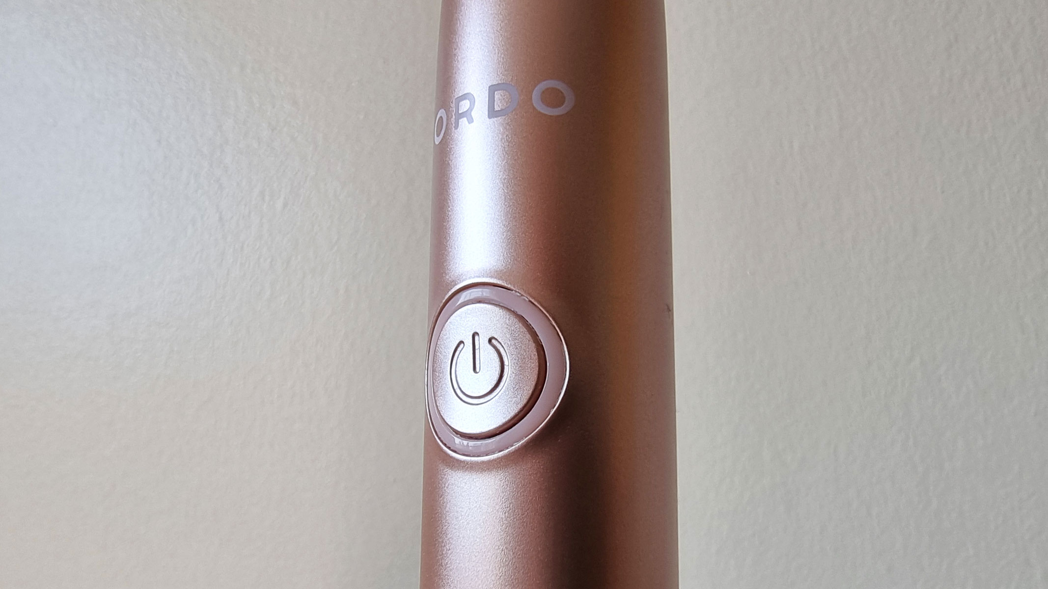 Ordo+ Sonic Electric Toothbrush, a close-up photo of the power button