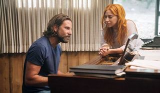Bradley Cooper and Lady Gaga around a piano in A Star is Born