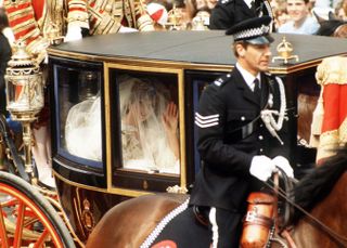 Lady Diana Spencer travels by coach to St Paul's Cathedral for her wedding to the Prince of Wales, 29th July 1981. She wears a wedding dress by David and Elizabeth Emmanuel and the Spencer family tiara. )