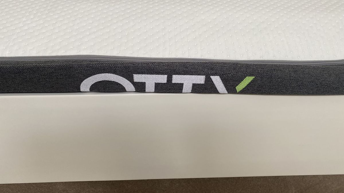 Side view of Otty Original Hybrid mattress before it has fully expanded