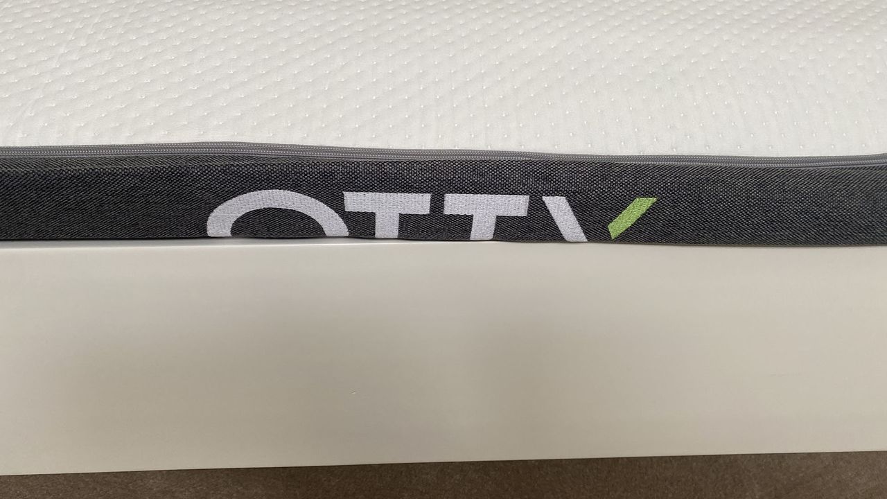 Side view of Otty Original Hybrid mattress before it has fully expanded