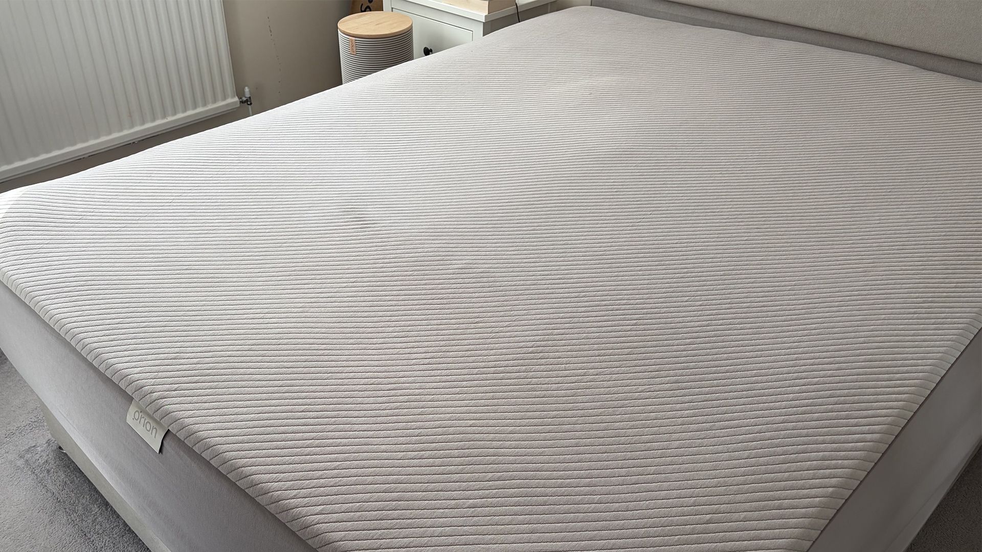 The Orion Sleep System on a mattress in our reviewer's bedroom. IN the background the Control Tower is visible