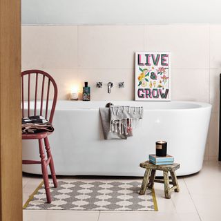 bathroom with freestanding bath, wooden stool and chair