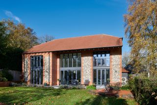 a self build home with a stone clad exterior