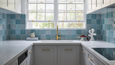 blue zellige tiled galley kitchen with light blue cabinets