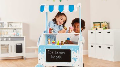 Aldi wooden toys: ice cream stand being played with by two children