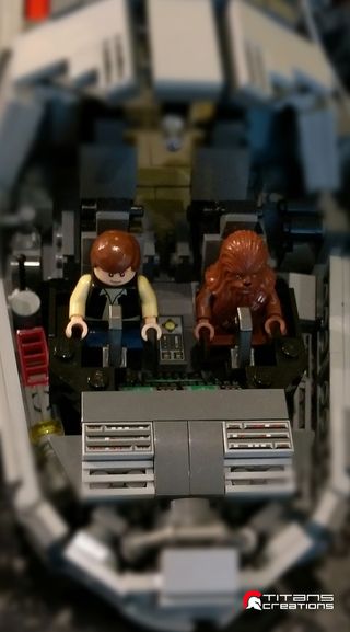 Han Solo and Chewbacca at the controls of Titans Creations' Lego Millennium Falcon.