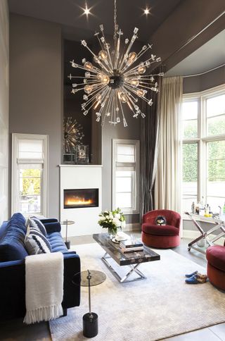 A living room with a warm light chandelier