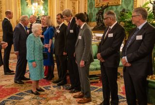Queen Elizabeth II (L) greets John Kerry, United States Special Presidential Envoy for Climate during a reception for international business and investment leaders