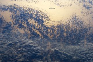 Astronauts aboard the International Space Station snapped this photo of clouds, their shadows and sunglint over the Pacific Ocean.