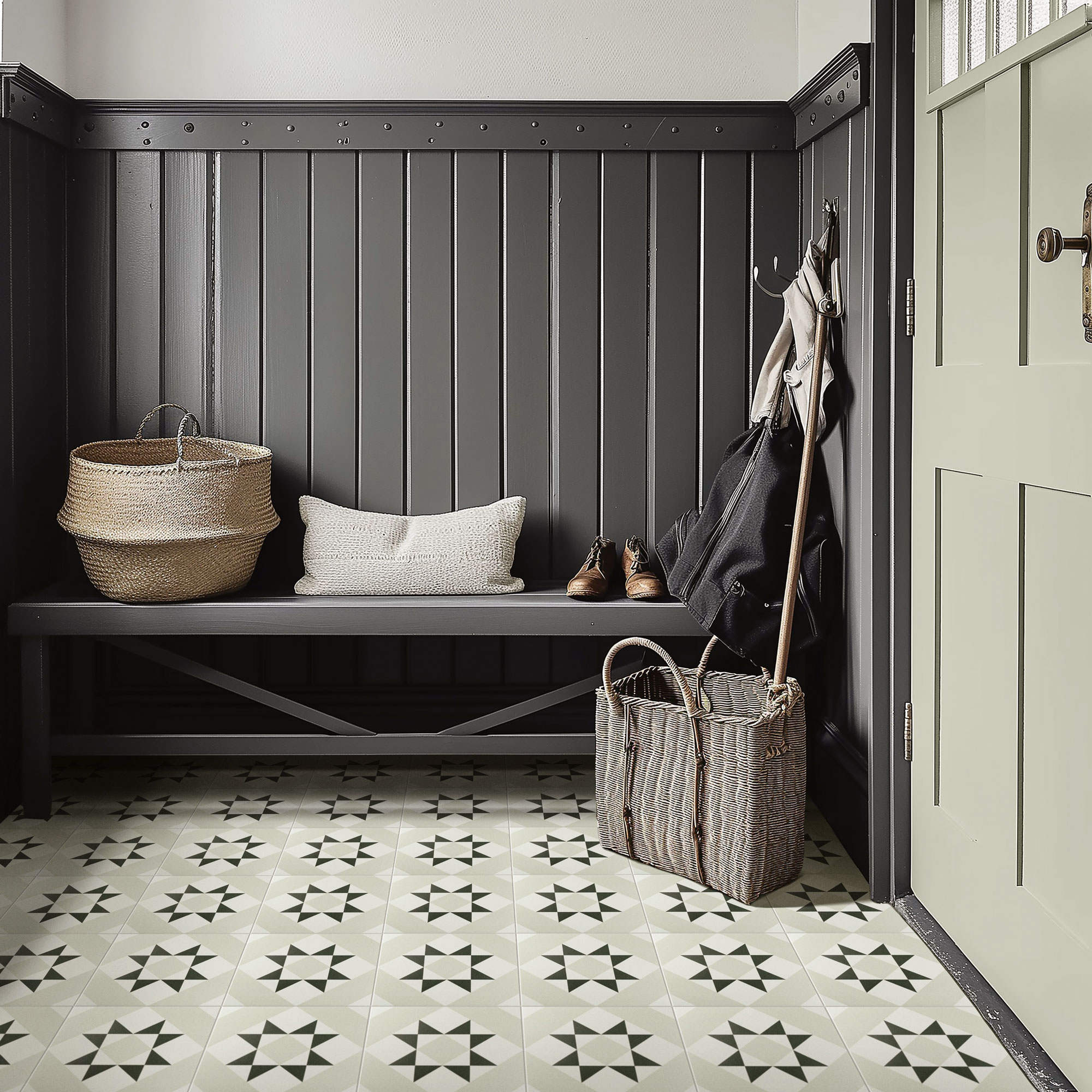 Grey pannelled hallway with tiled flooring and a grey bench with baskets and a cushion on