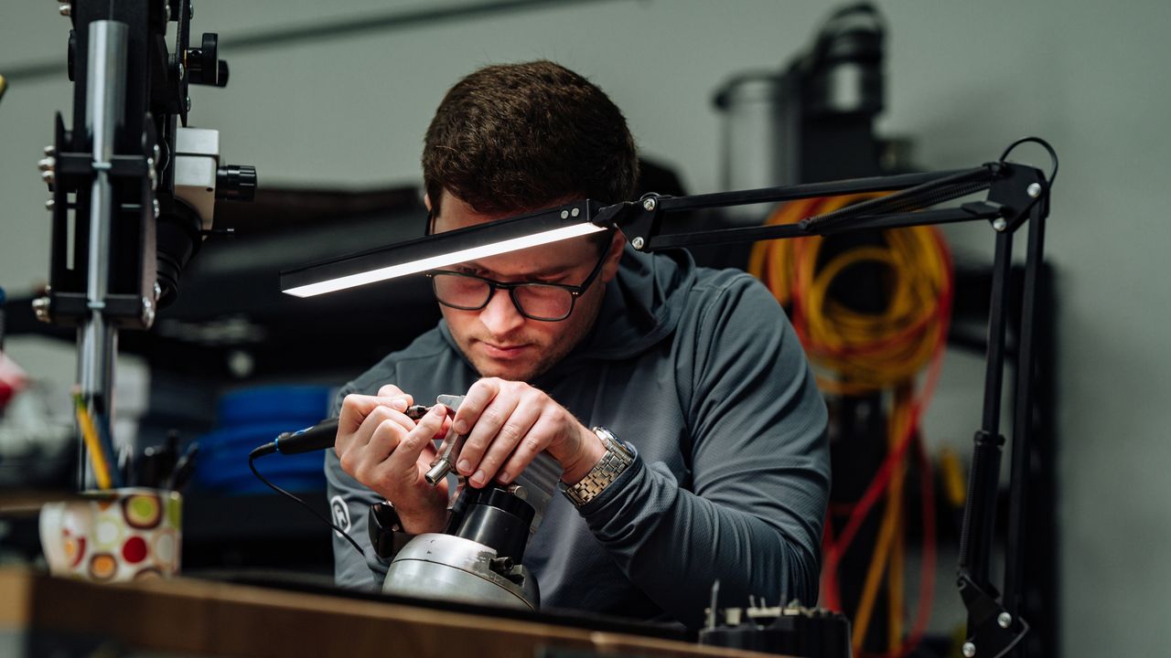 Logan Olson working on a putter in his workshop