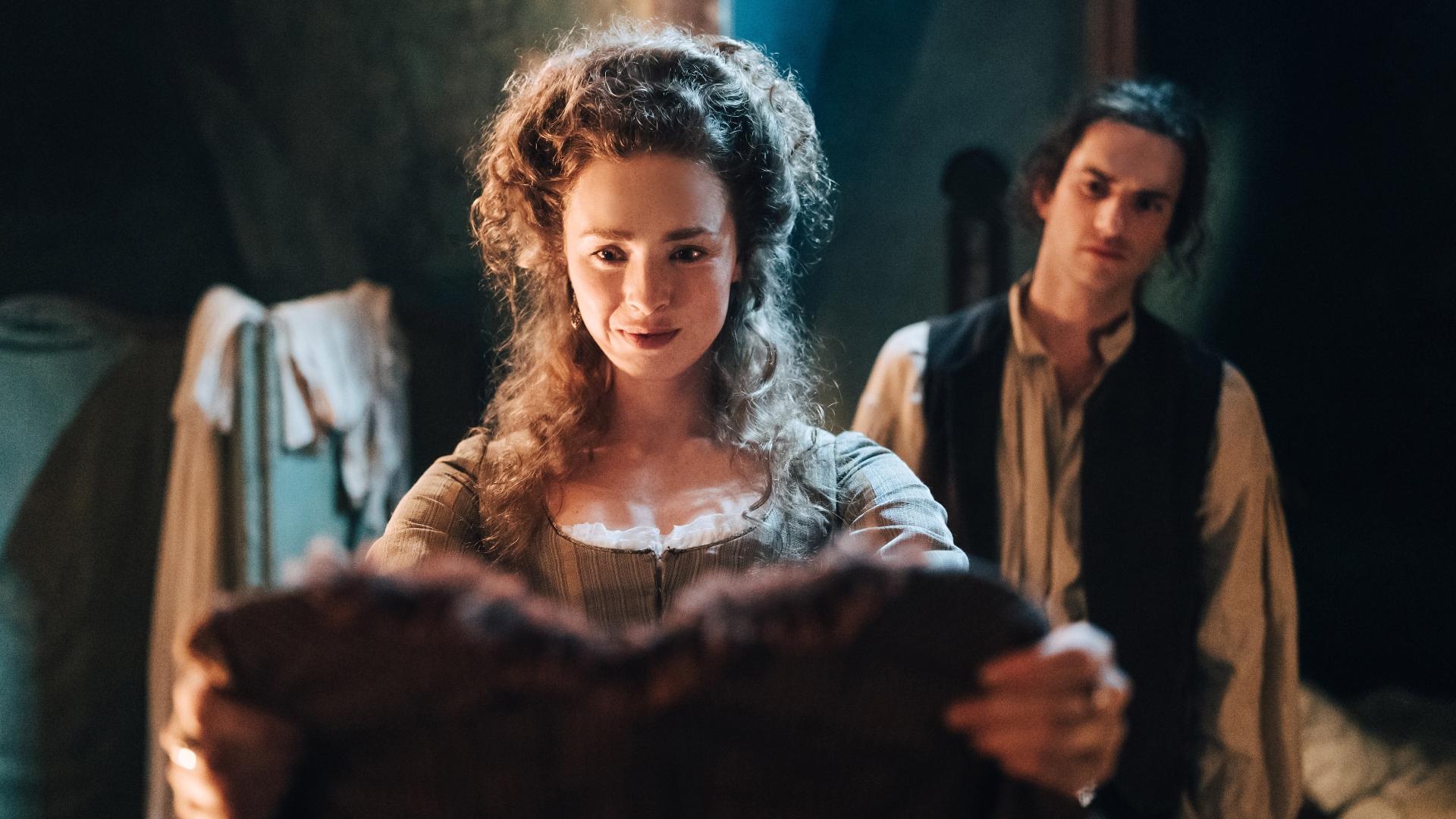 Jeanne holds up her new gown in Marie Antoinette