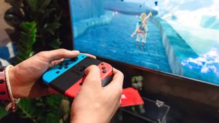 Someone playing The Legend of Zelda: Breath of the Wild on a Nintendo Switch