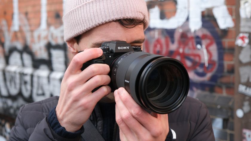Sony a1 II camera with a Sony FE 28-70mm f/2 GM lens attached held up to a person&#039;s face