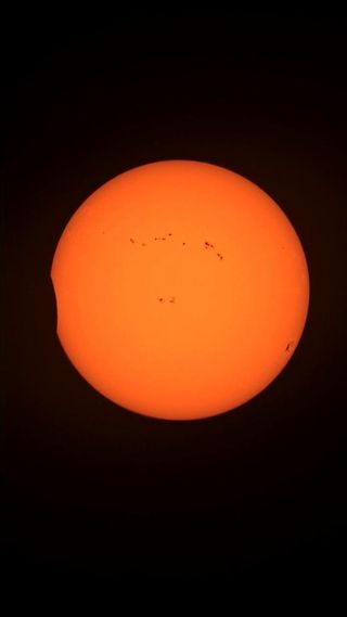 first views of the annular eclipse as the moon appears to take a bite out of the sun.