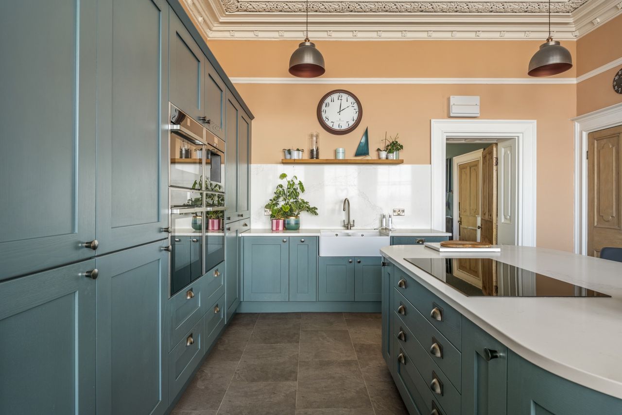 Detail of the interiors of Woodside, featuring lots of soft blues, funky artwork, wooden floors, and natural light