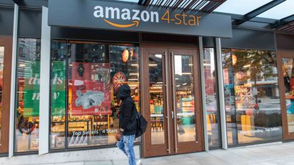  Person Wearing Hoody and Gloves Walks Outside Amazon 4-Star Store