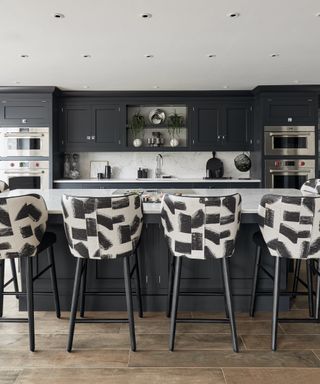 Dark gray kitchen with graphic print bar stools