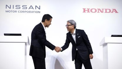 Nissan's Makoto Uchida and Honda's Toshihiro Mibe shake hands on collaboration