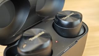 Panasonic Technics EAH-AZ80 earbuds sitting on a desk