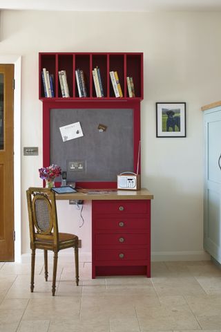 red desk with blackboard and cubby hole storage