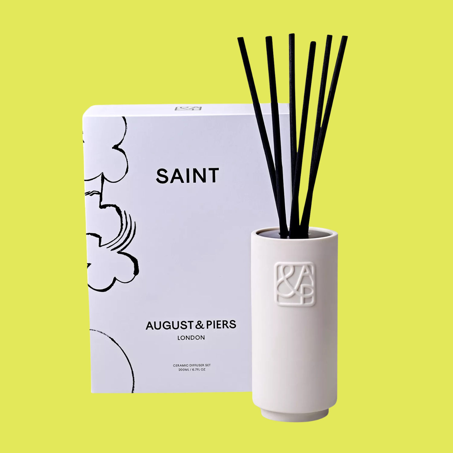 A ceramic reed diffuser by a box