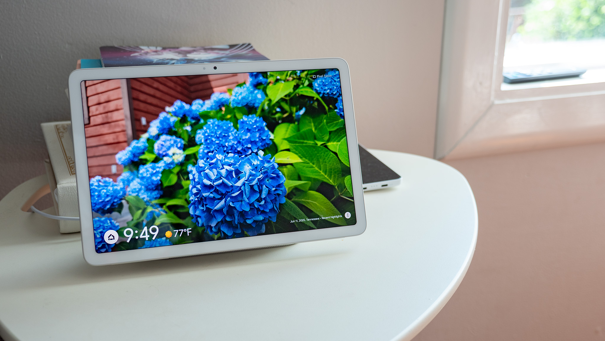The Google Pixel Tablet showing a picture of a deep blue hydrangea, pulled from Google Photos while docked
