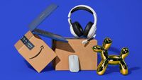 Prime Big Deal Days 2024 - laptop, mouse, gaming headset, two Amazon prime boxes and a gold balloon animal against a blue backgtround