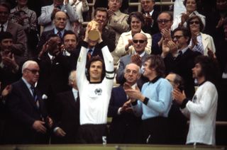 Franz Beckenbauer lifts the World Cup trophy after West Germany's win over the Netherlands in the 1974 final.