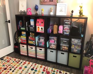 An-organised-playroom-with-stuff-stored-in-boxes-in-a-shelving-unit