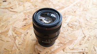 The Sony FE 50mm f1.4 on a chipboard surface