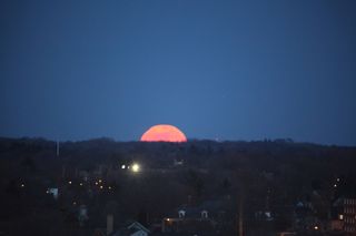 What appears to be an enormous full moon begins to rise over Grand Rapids, Michigan in this amazing photo from skywatcher Susan Wagener taken on March 19, 2011.