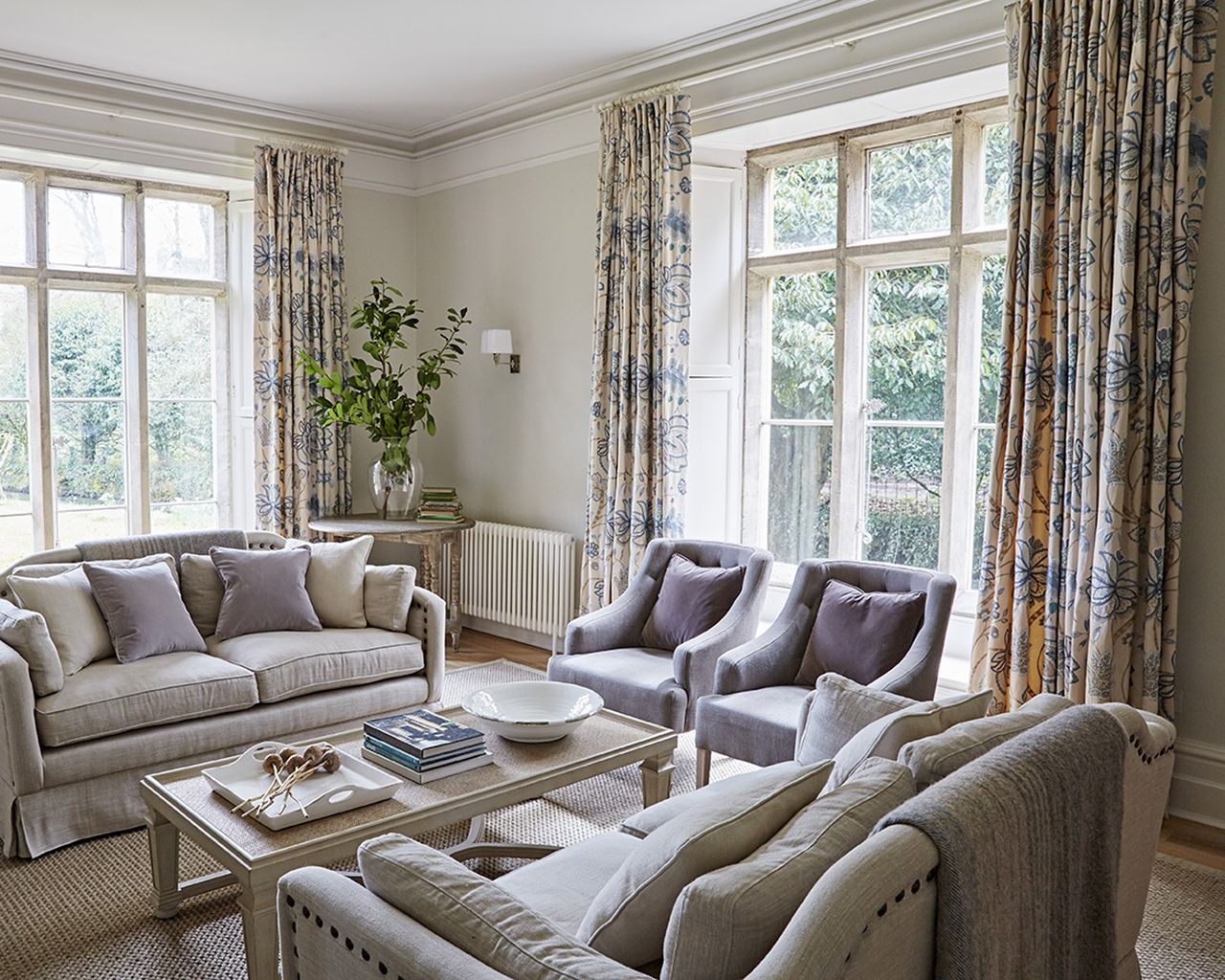 Large window curtain ideas with heavy patterned curtains in a neutral living room
