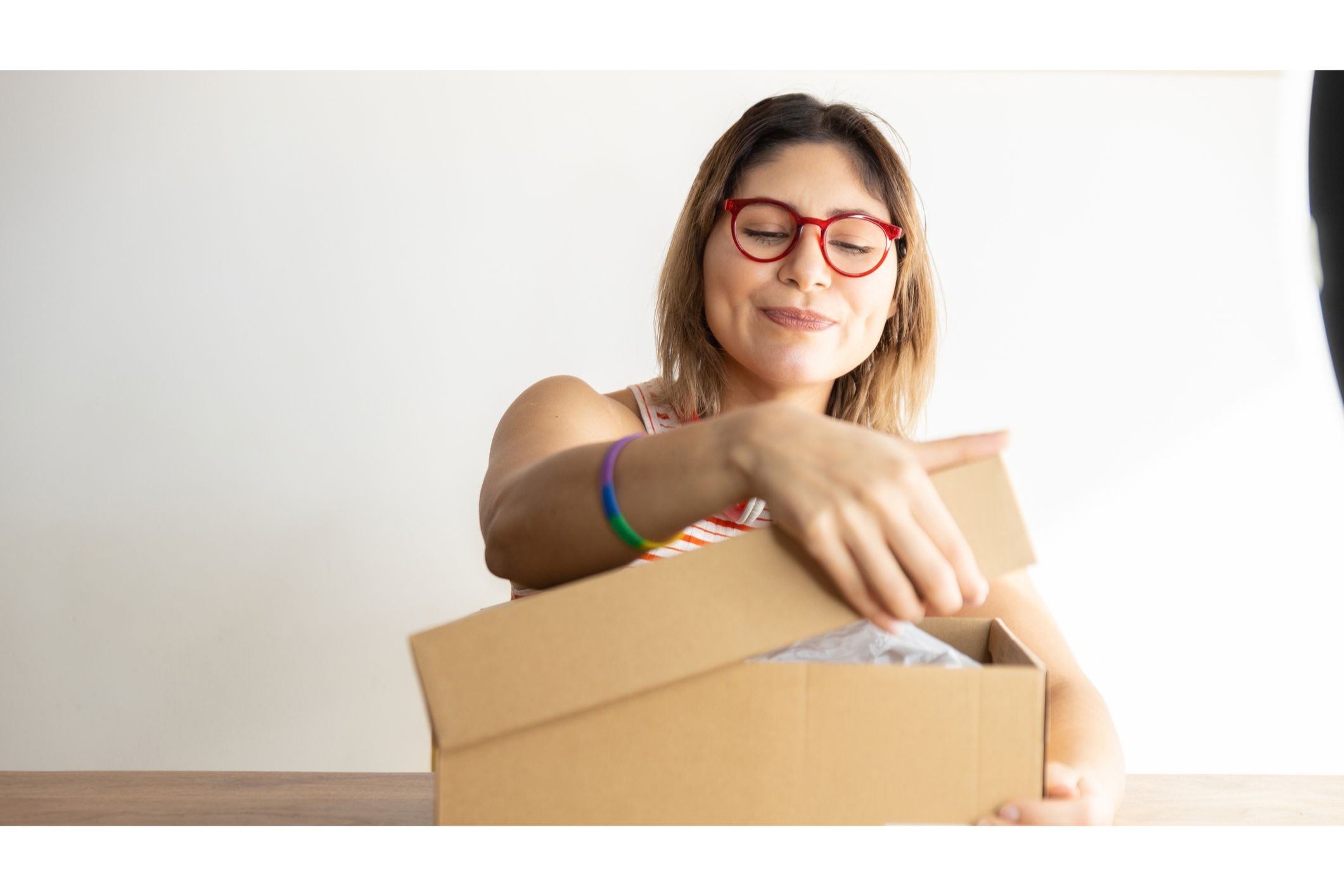 Woman opening brown cardboard shoebox