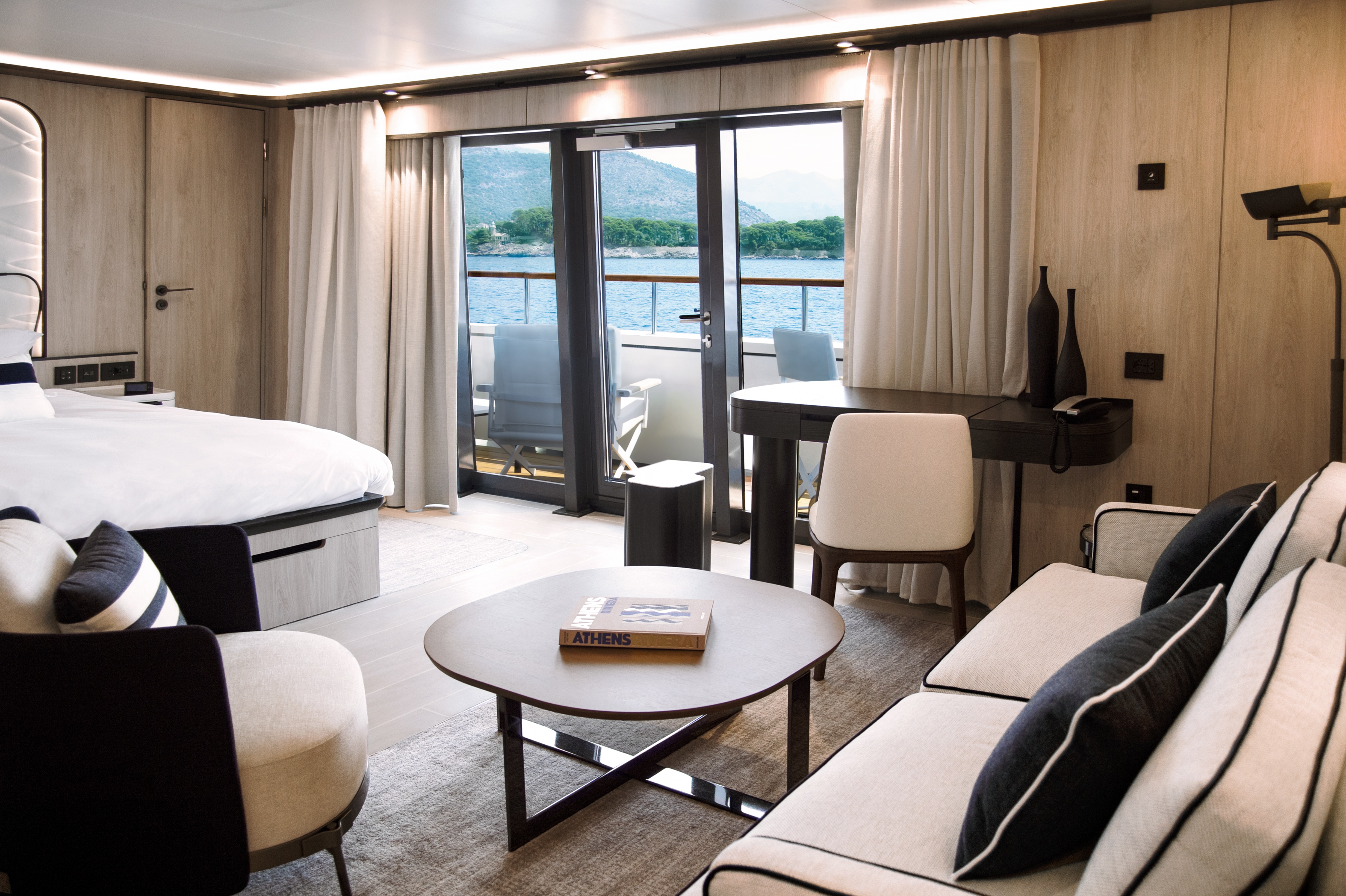 Luxury yacht interior in bleached wood and white and navy upholstery