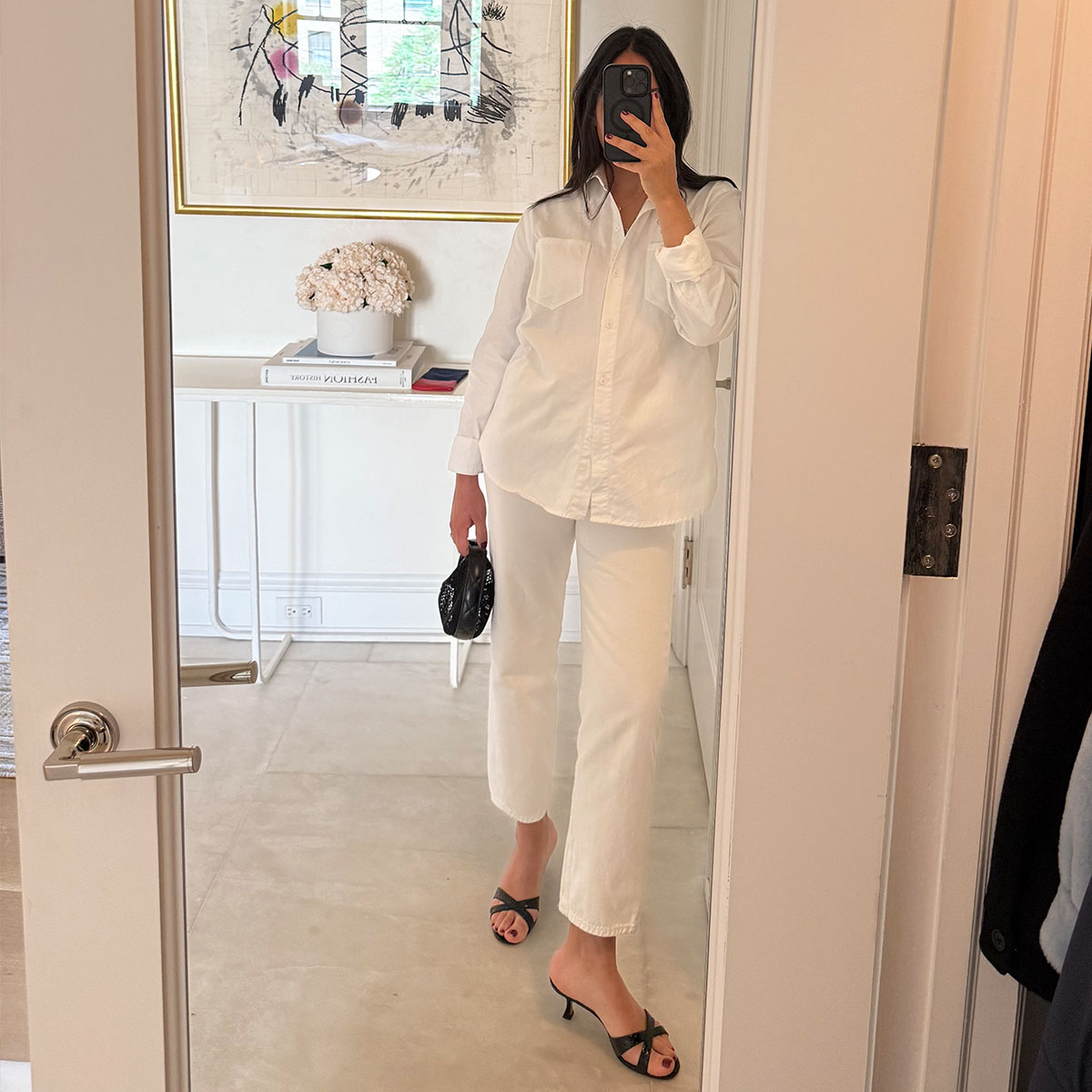 @nicoleakhtarzad mirror selfie in white outfit with black bag and sandals