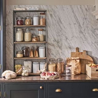 kitchen counter with food stored in jars on open shelving